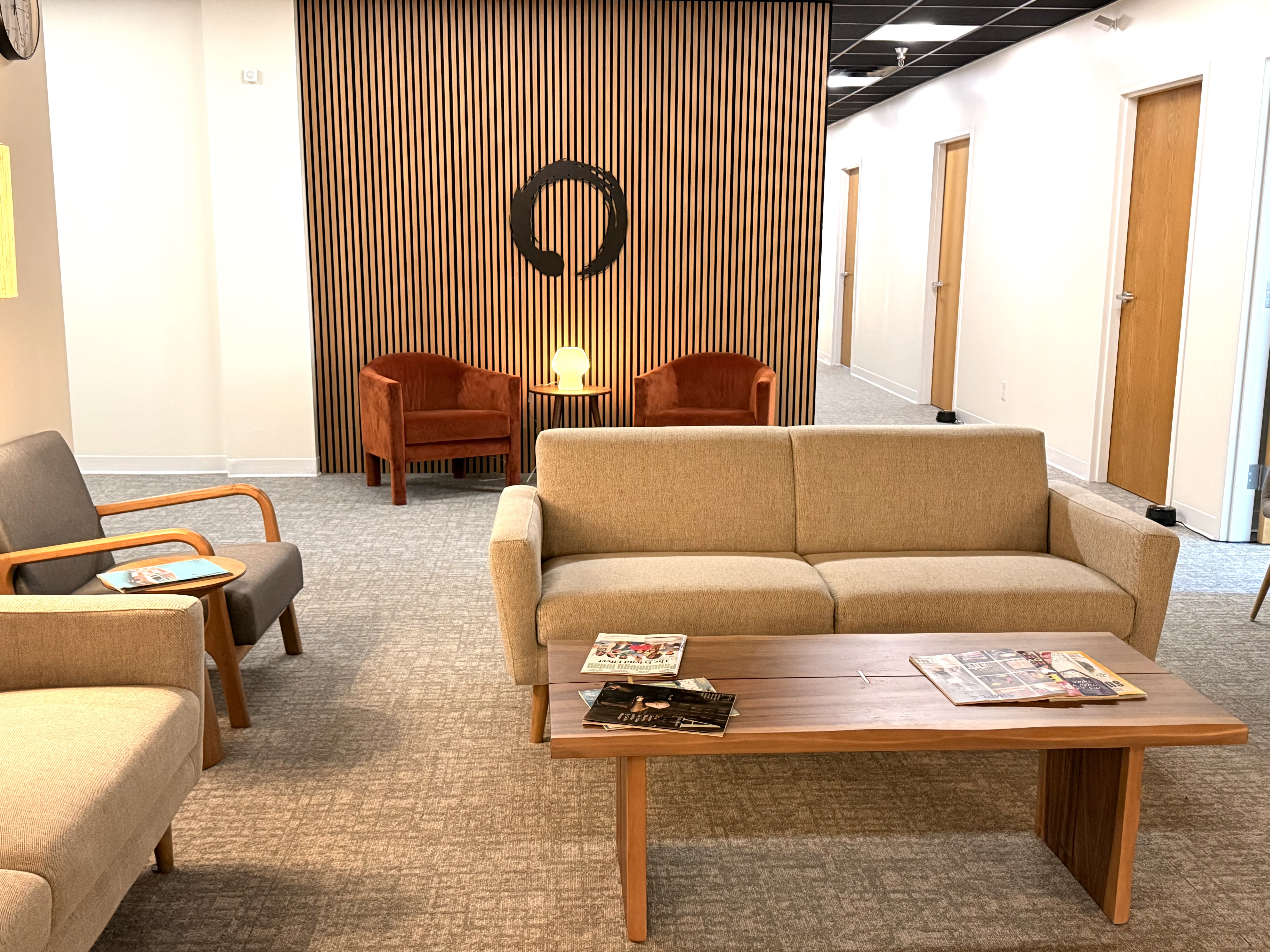 Seva Counseling waiting area with comfortable seating and warm wood accents.